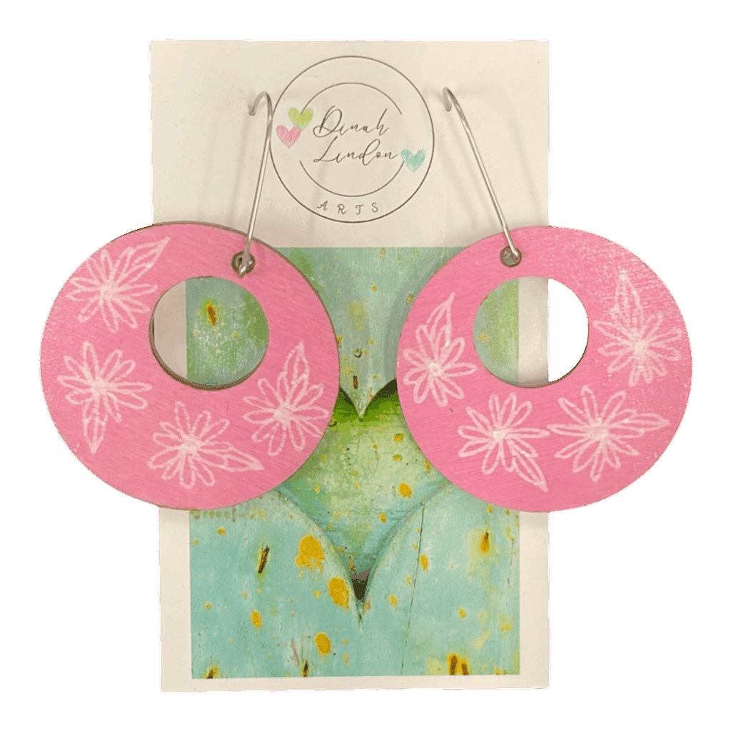 Bubblegum Blossom Hoops – pink hoops with delicate white floral designs, handpainted on lightweight wood by Dinah Lindon.