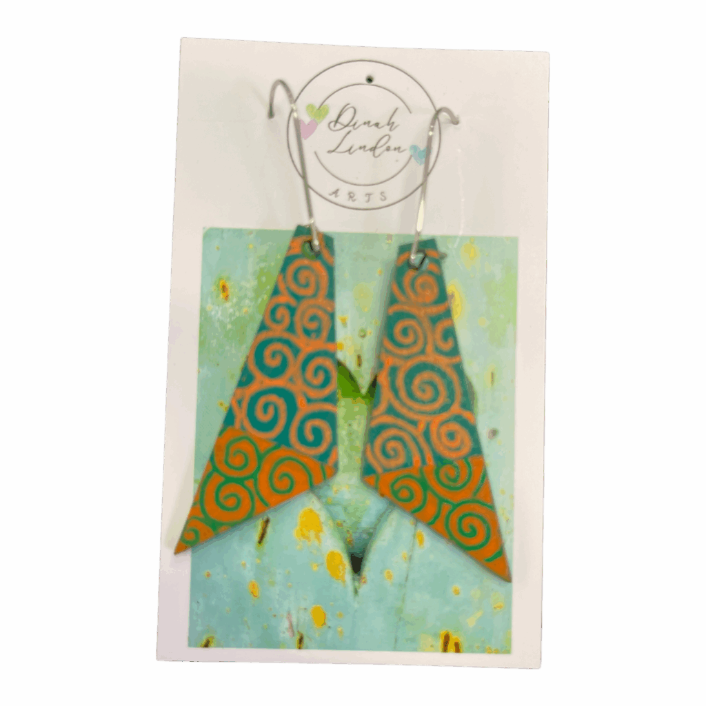 Desert Spiral Arrows – orange and teal arrowhead earrings with handpainted spiral patterns and a glossy finish by Dinah Lindon.