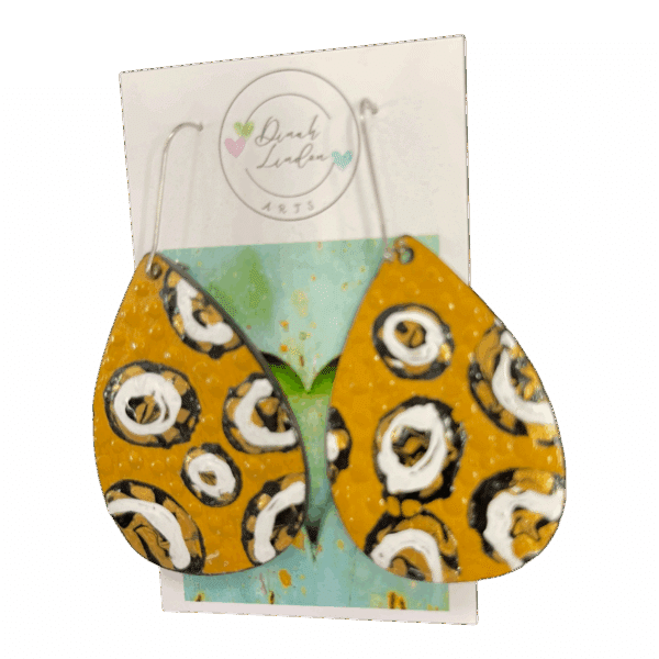 Honey Dot Drops – mustard yellow earrings with bold black and white circular motifs and a glossy finish.