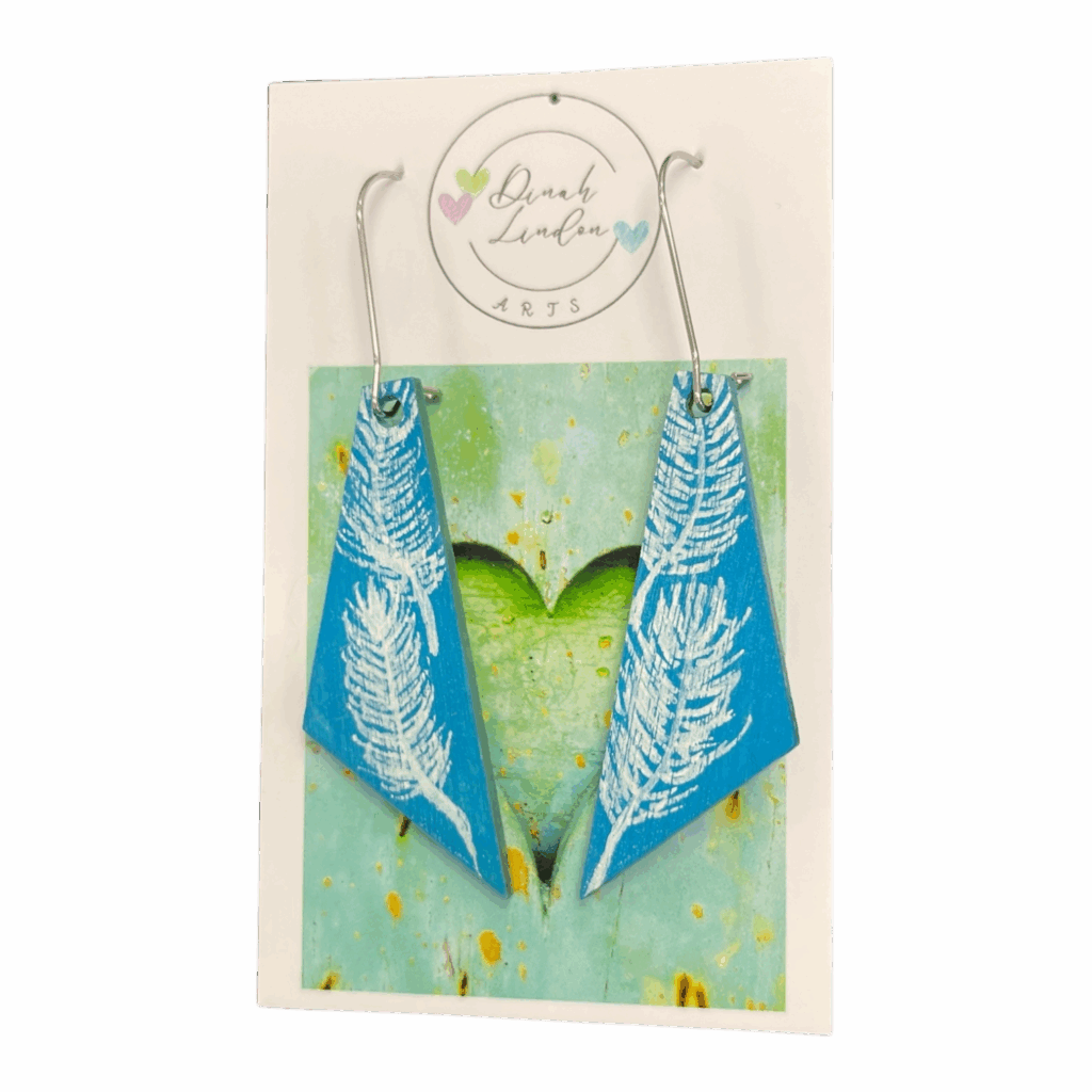 Featherlight Arrows – soft blue earrings with white handpainted feathers in a modern angled shape by Dinah Lindon Artist.