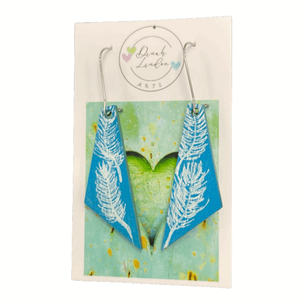 Featherlight Arrows – soft blue earrings with white handpainted feathers in a modern angled shape by Dinah Lindon Artist.