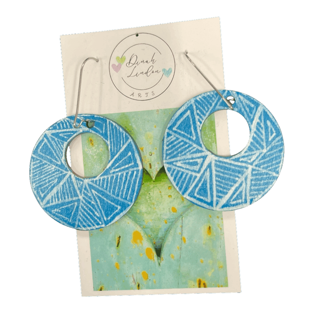 Sky Lines Hoops – lightweight round earrings in sky blue with crisp white geometric linework.