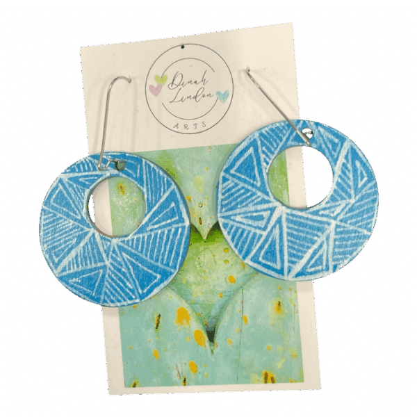 Sky Lines Hoops – lightweight round earrings in sky blue with crisp white geometric linework.