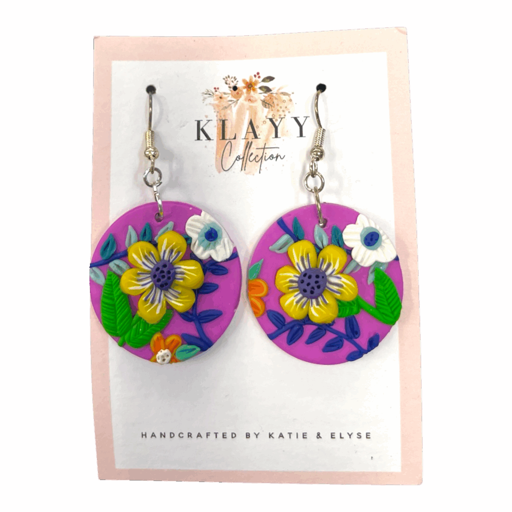 Sunshine Bloom earrings pop with cheerful yellow flowers on bright pink clay. Handmade fun for everyday wear.