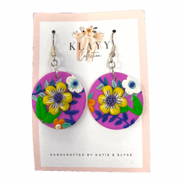Sunshine Bloom earrings pop with cheerful yellow flowers on bright pink clay. Handmade fun for everyday wear.