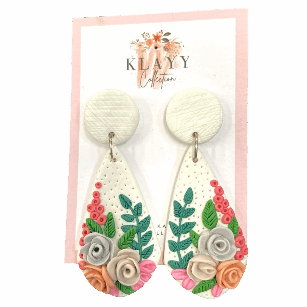 Garden Stroll earrings feature a spring-inspired floral bouquet on white clay with soft roses and greenery. Fresh, feminine, and handmade.