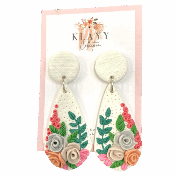 Garden Stroll earrings feature a spring-inspired floral bouquet on white clay with soft roses and greenery. Fresh, feminine, and handmade.