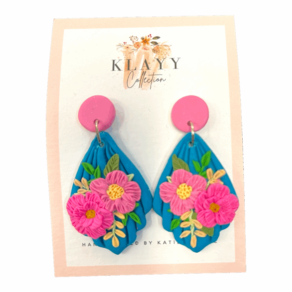 Island Bouquet earrings feature hot pink blooms on vivid blue with candy-pink studs. Bright, bold, and beach-ready.