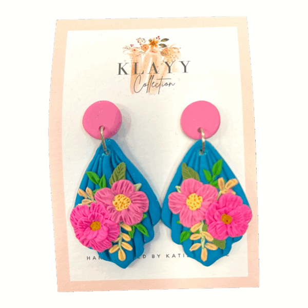 Island Bouquet earrings feature hot pink blooms on vivid blue with candy-pink studs. Bright, bold, and beach-ready.