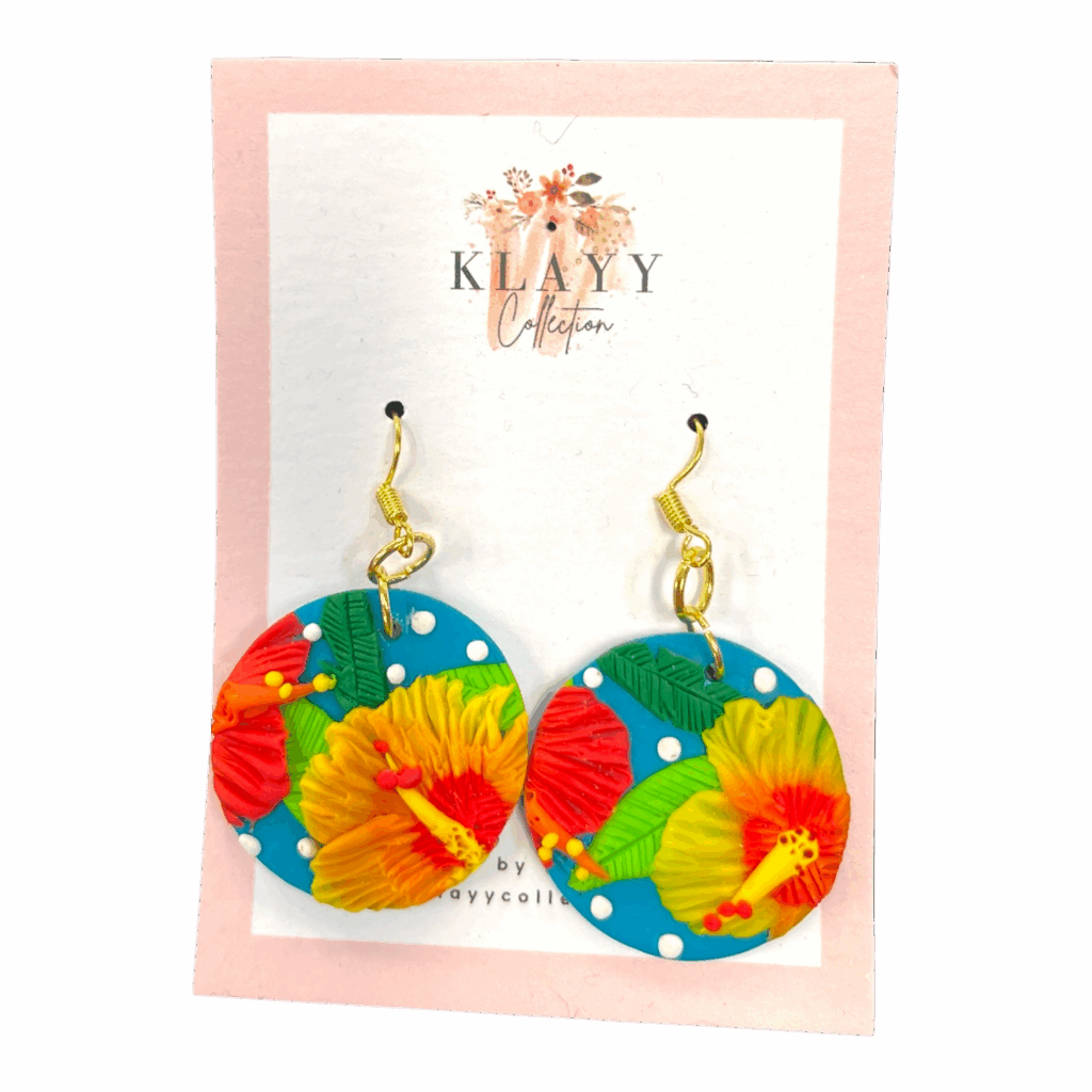 Tropicana Dots earrings showcase tropical florals on teal clay with white polka dots. Handmade fun for summer lovers.