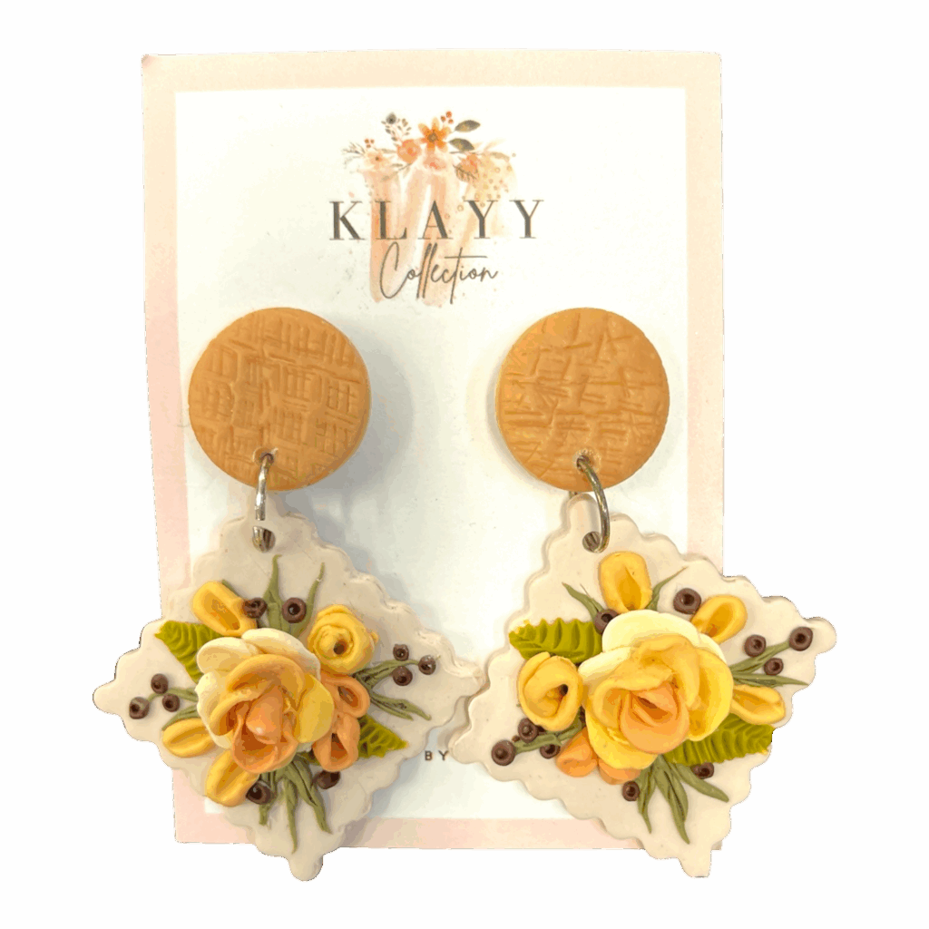 Lemon Meringue earrings combine yellow florals with earthy greens on a soft clay base. Bright, warm, and handmade.