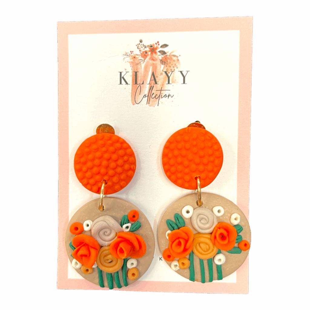 Clementine Bloom earrings feature vibrant orange studs and blooming florals in citrus shades. Bright, bold, and handmade fun.