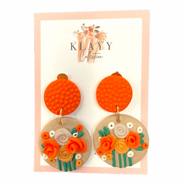 Clementine Bloom earrings feature vibrant orange studs and blooming florals in citrus shades. Bright, bold, and handmade fun.