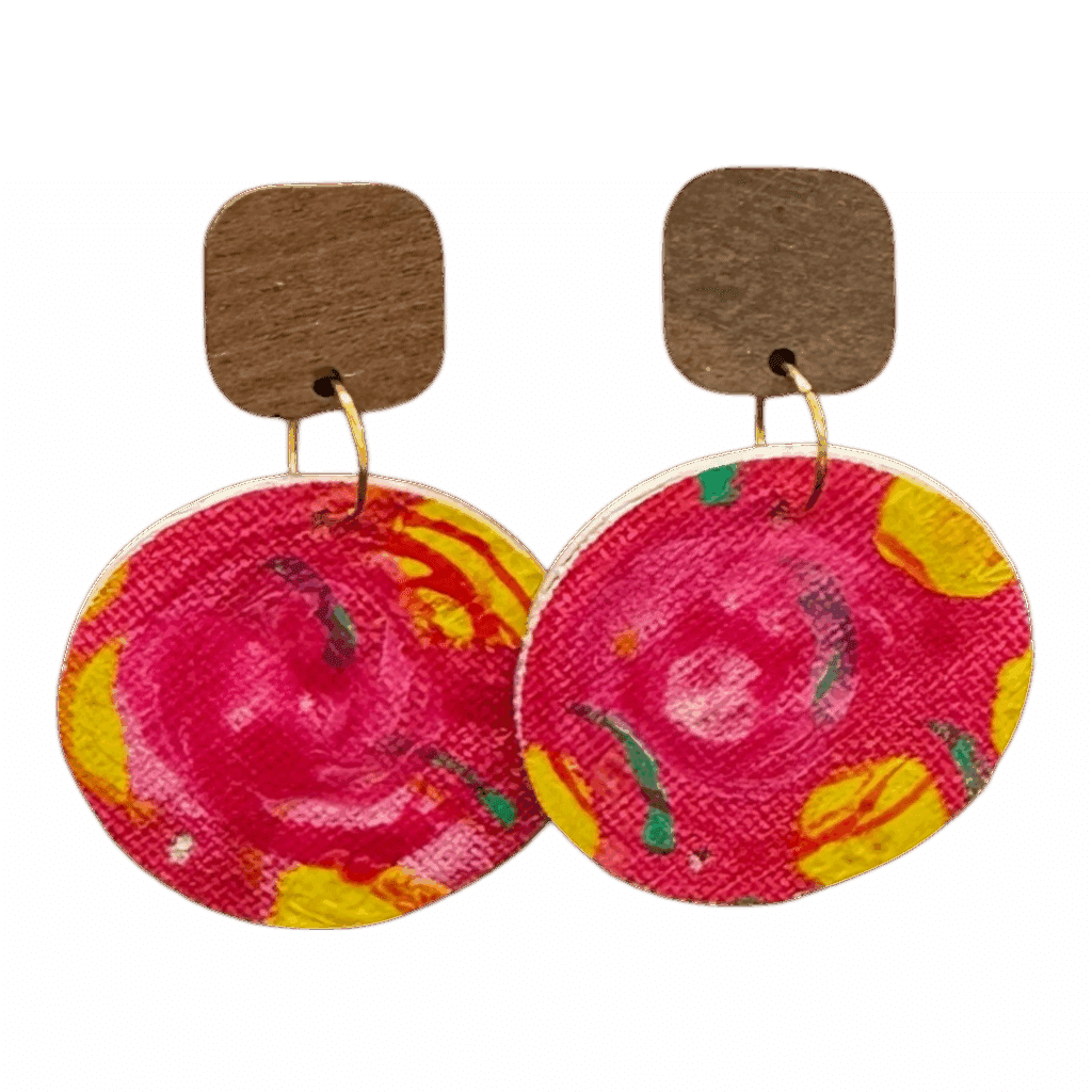 “Sunset Swirl” hand-painted earrings by Lindy Farley — pink, yellow, and orange eco art made from recycled coffee pods.